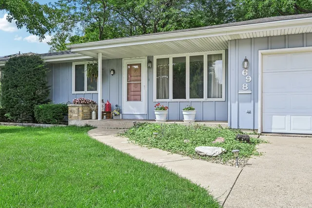 an aerial view of residential houses with outdoor space and trees