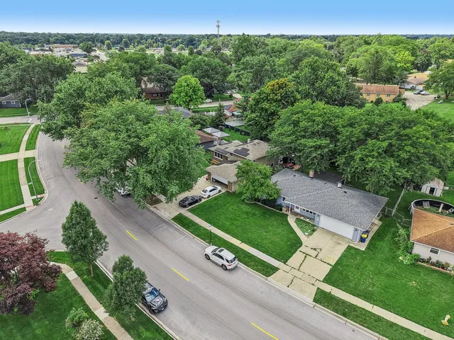 an aerial view of residential houses with outdoor space and street view