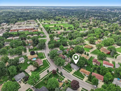 a front view of a house with a garden and yard