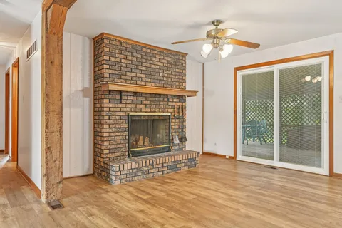 a view of a kitchen with a sink cabinets and a fireplace