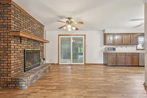 a view of a livingroom with a fireplace and wooden floor