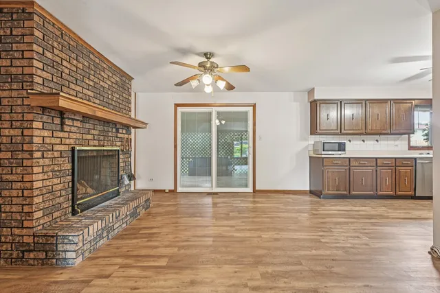 a view of a livingroom with a fireplace and wooden floor