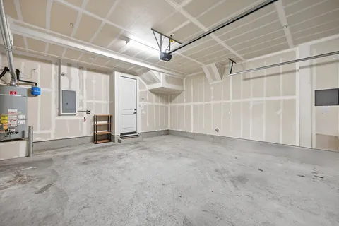 a view of a house with a small yard and floor to ceiling window