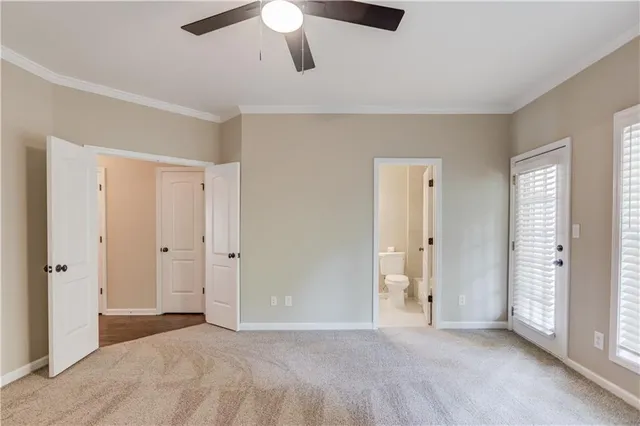 a view of an empty room with a ceiling fan