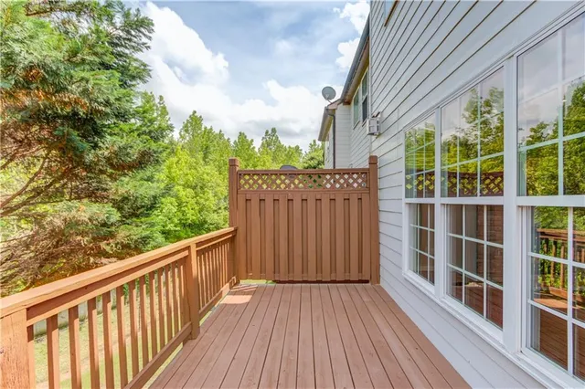 a view of balcony with wooden floor and fence