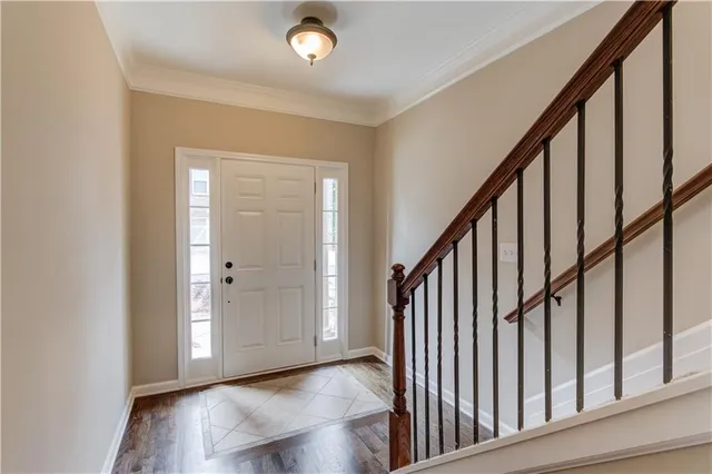 a view of an entryway with wooden floor