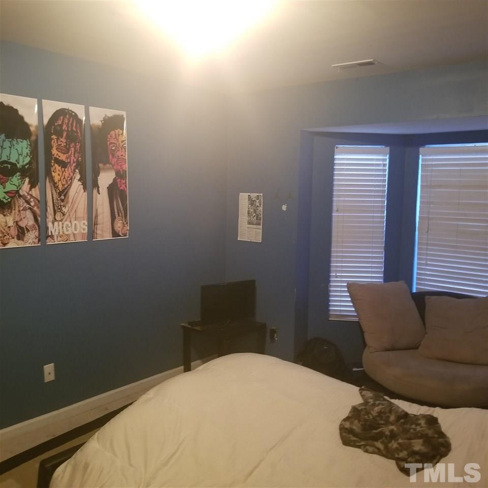 5330 Glen Canyon Road Raleigh, NC 27616 - Photo 11 of 15 a bedroom with a bed and a couch