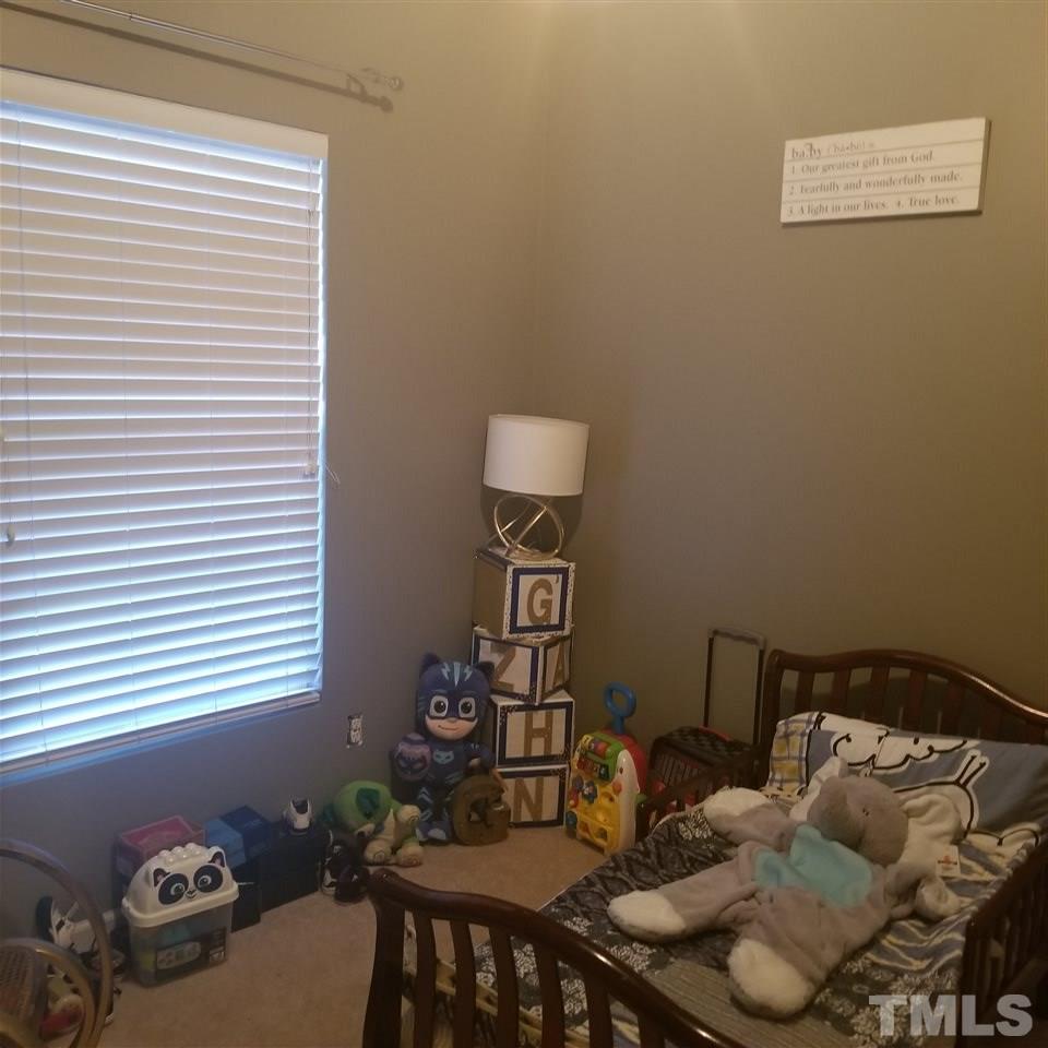 5330 Glen Canyon Road Raleigh, NC 27616 - Photo 12 of 15 a bedroom with a bed and a window