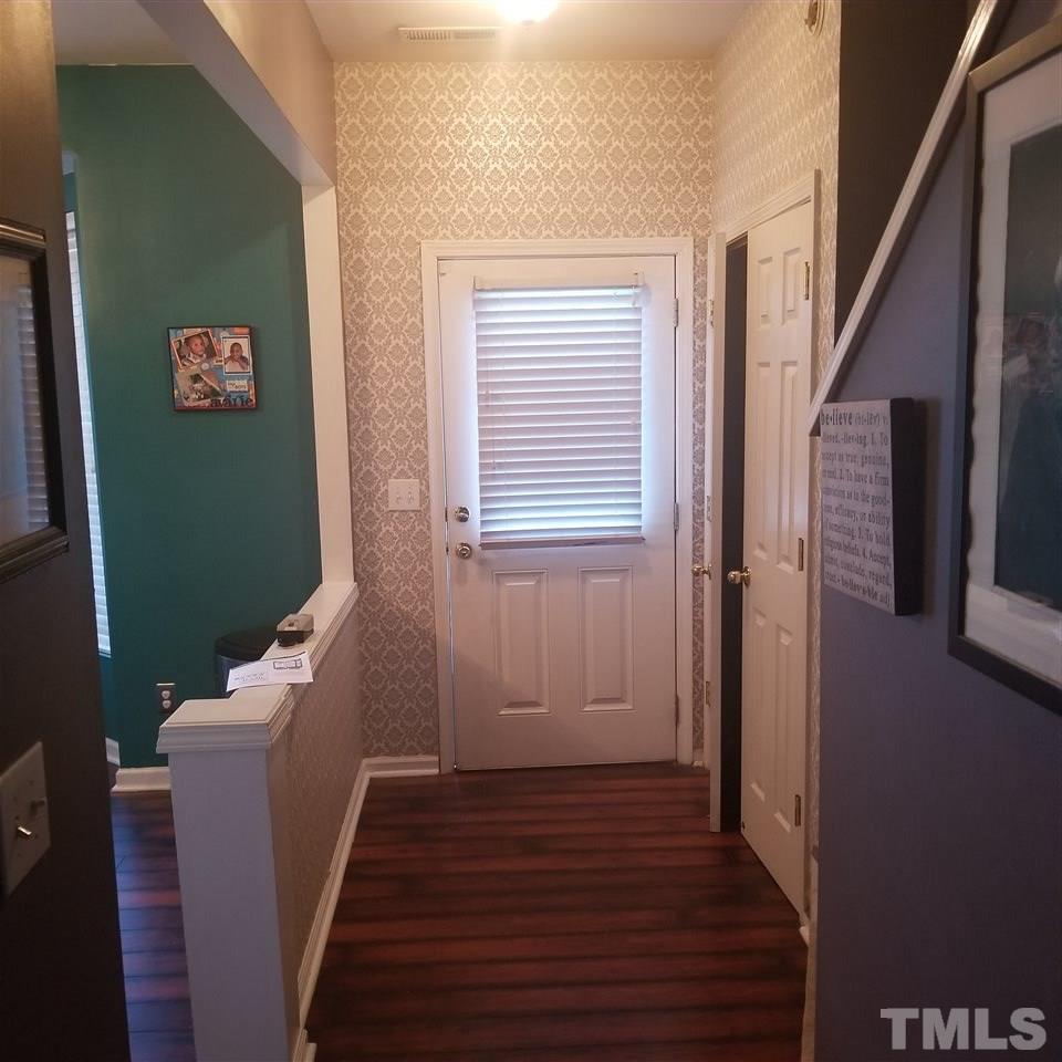 5330 Glen Canyon Road Raleigh, NC 27616 - Photo 5 of 15 a view of a hallway with wooden floor and stairs