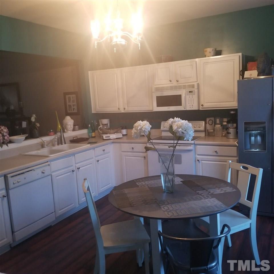 5330 Glen Canyon Road Raleigh, NC 27616 - Photo 6 of 15 a kitchen with a dining table and chairs