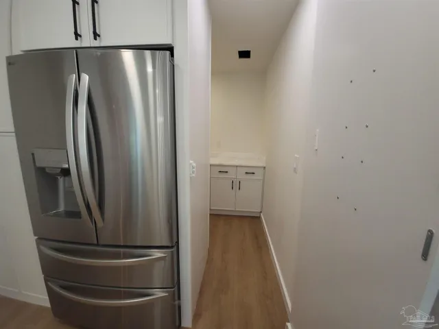 a view of a refrigerator in kitchen