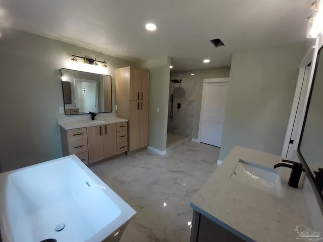 a bathroom with a sink a mirror and a toilet