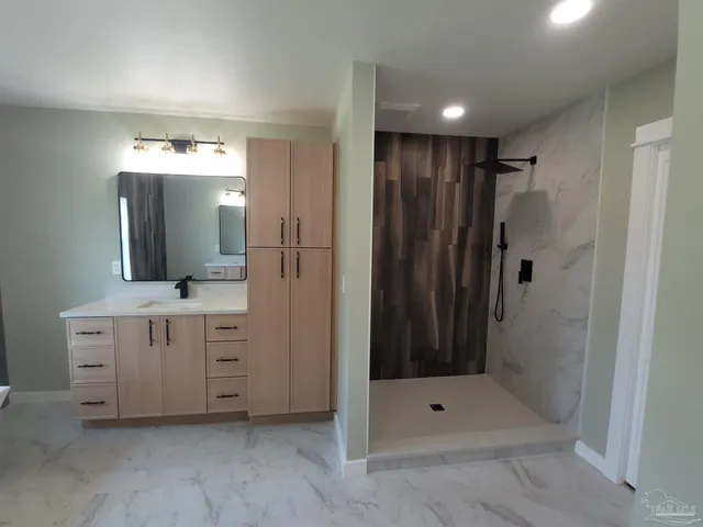 a bathroom with a double vanity sink mirror and shower