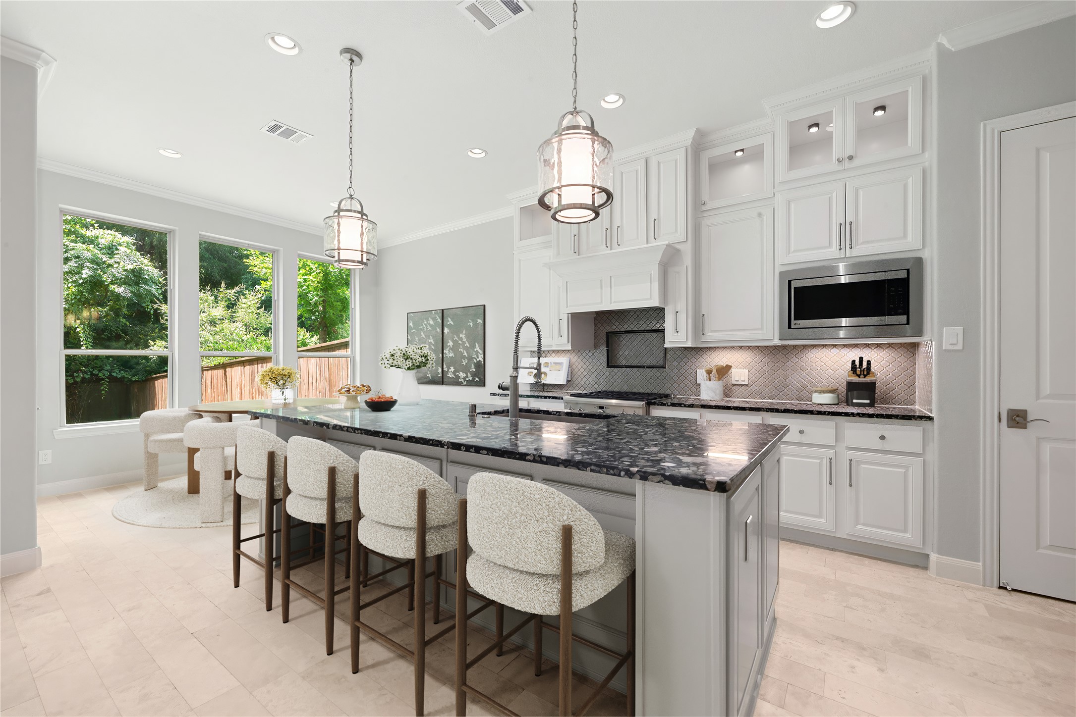 98 Herons Flight Place Spring, TX 77389 - Photo 7 of 29 Chef's kitchen featuring an oversized granite island, pendant lighting, and an open flow to the breakfast area. *Virtually Staged