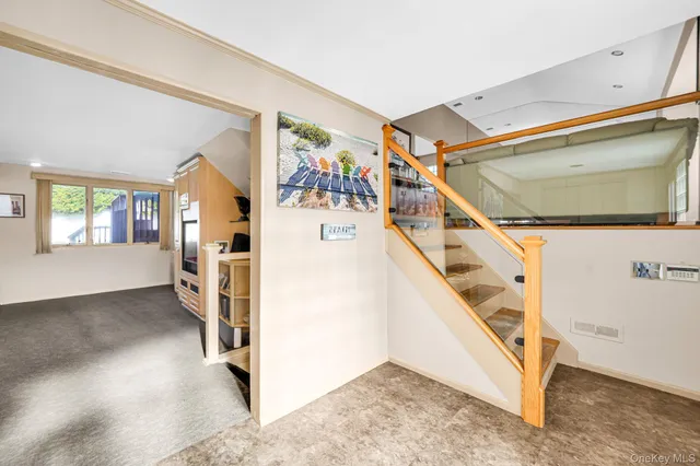 a view of hallway with stairs and furniture