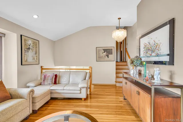 a living room with furniture and a chandelier