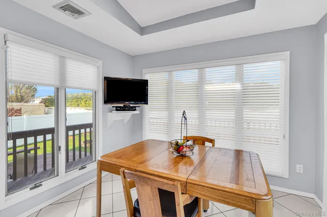 a view of a dining room with furniture window and outside view
