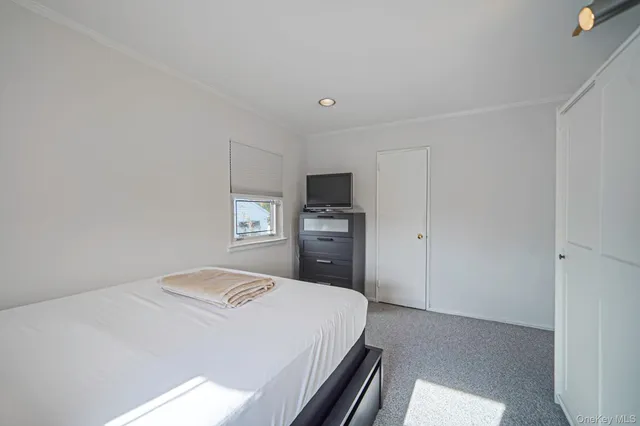 a bedroom with a bed and a tv