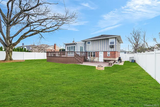 a view of a house with a backyard and a patio