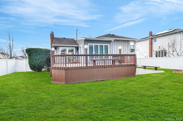 a view of a house with a yard and deck