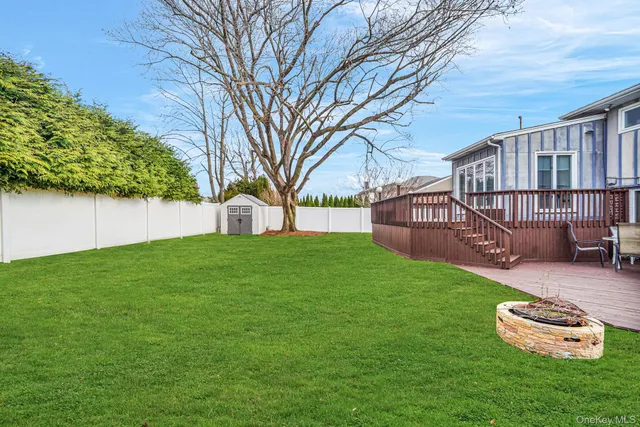 a view of a house with backyard and a tree