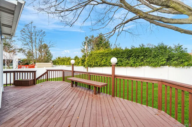 a view of balcony with wooden floor and fence