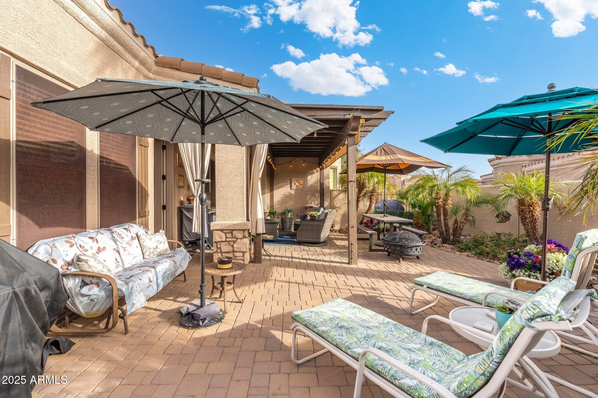 6202 East McKellips Road, Unit 235 Mesa, AZ 85215 - Photo 13 of 14 a view of a patio with a table and chairs under an umbrella