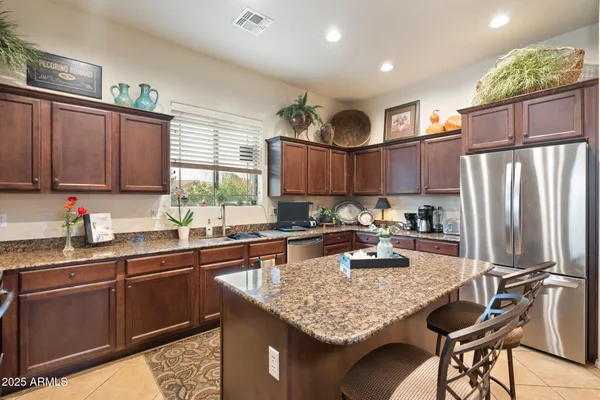 a kitchen with granite countertop a sink appliances and cabinets