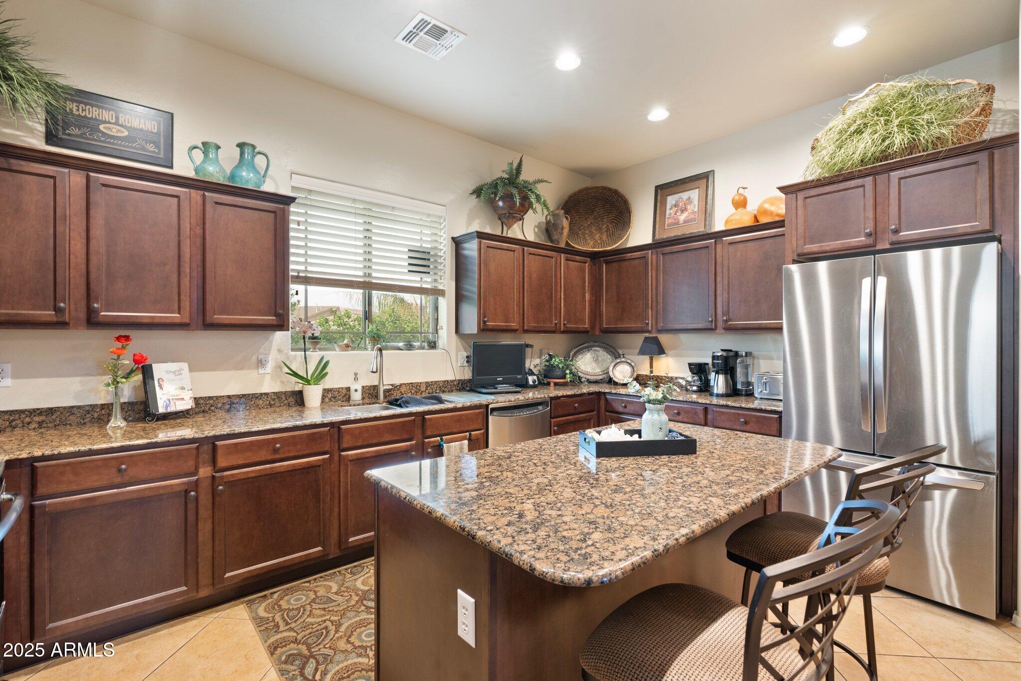 6202 East McKellips Road, Unit 235 Mesa, AZ 85215 - Photo 3 of 14 a kitchen with granite countertop a sink appliances and cabinets