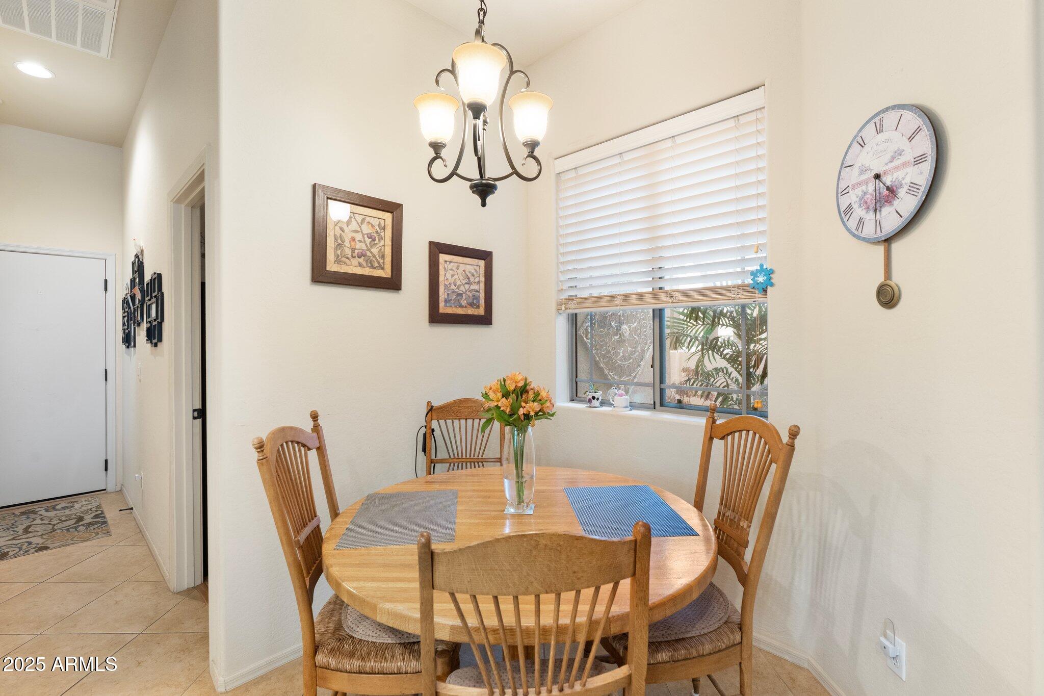 6202 East McKellips Road, Unit 235 Mesa, AZ 85215 - Photo 6 of 14 a view of a dining room with furniture window and wooden floor