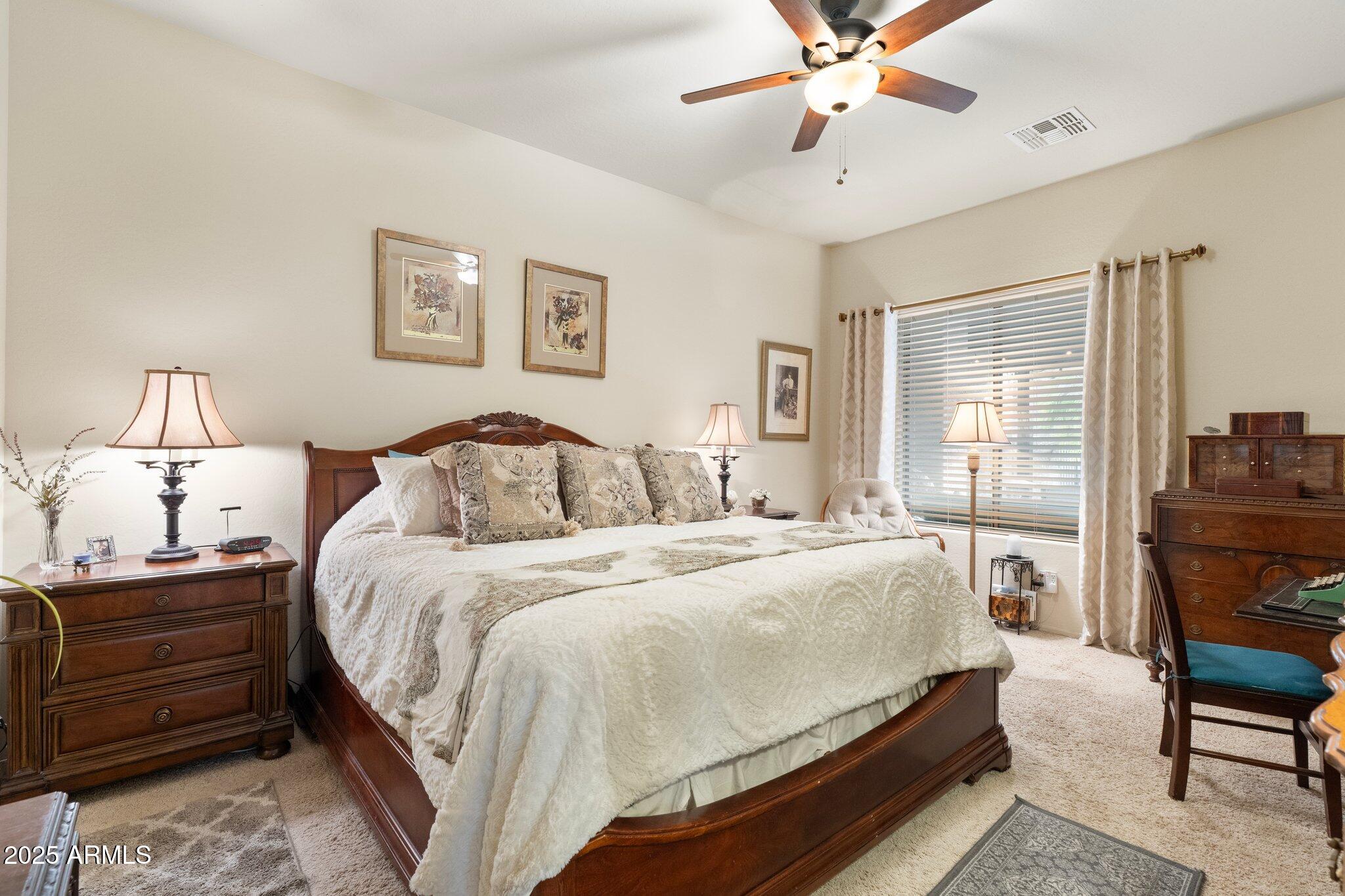 6202 East McKellips Road, Unit 235 Mesa, AZ 85215 - Photo 7 of 14 a bedroom with a bed and wooden floor