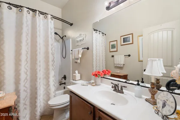 a bathroom with a sink vanity mirror and toilet