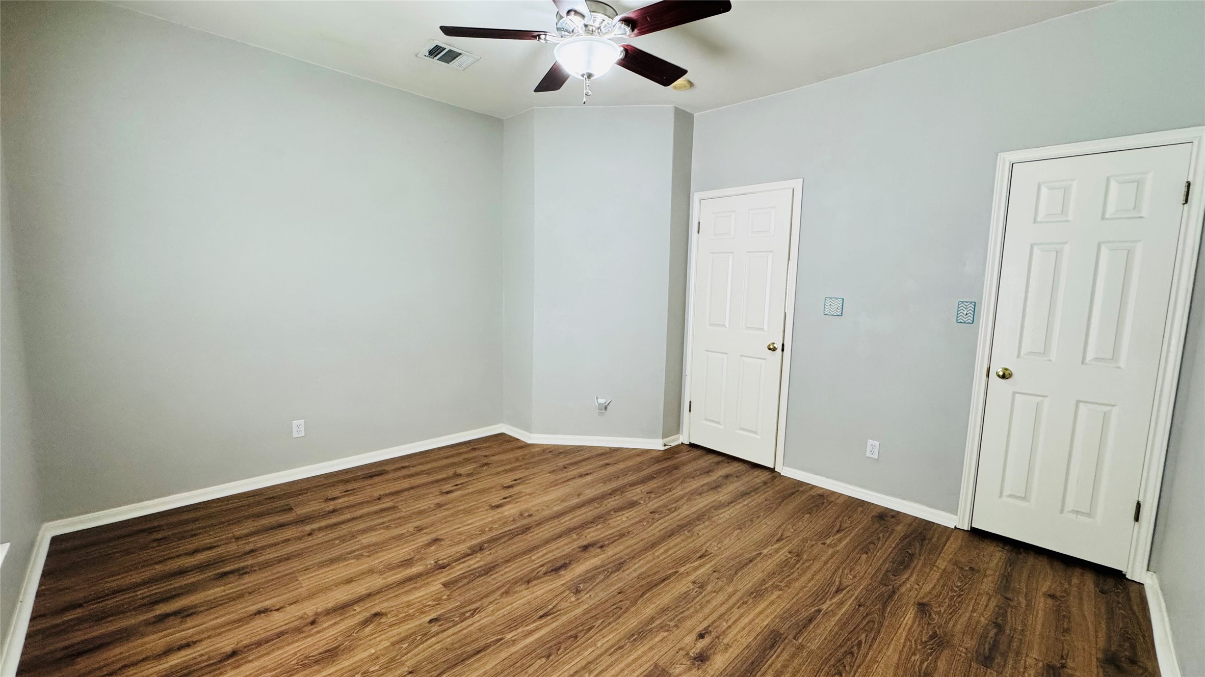 401 Witte Road Kyle, TX 78640 - Photo 7 of 9 Bedroom 2-A quiet bedroom with rich wood flooring offers a serene retreat.