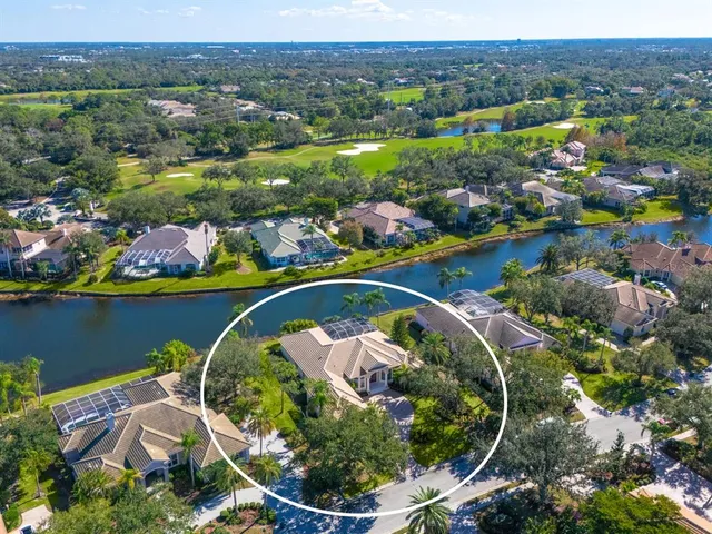 an aerial view of a house with a lake view
