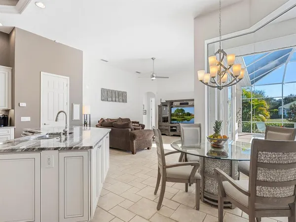 a large bathroom with a granite countertop sink a mirror a bathtub and next to a window