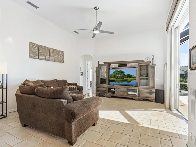 a view of a livingroom with wooden floor and mirror