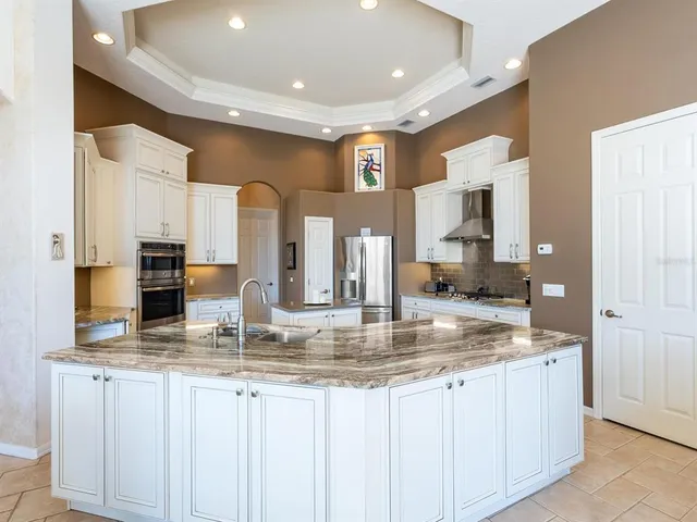 a bathroom with a granite countertop sink a toilet and a mirror