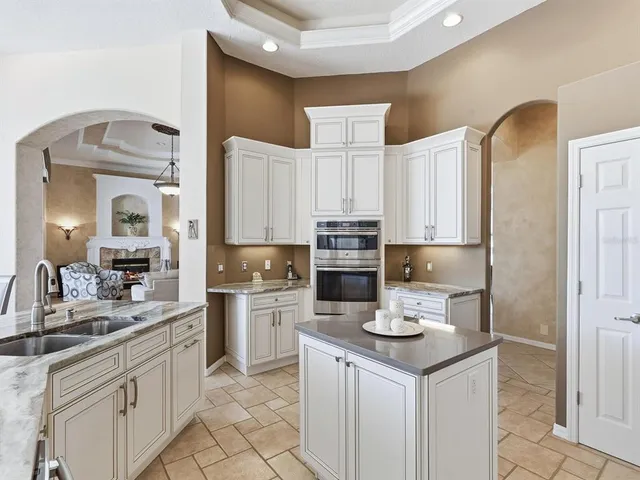 a bathroom with a granite countertop sink a toilet and a mirror