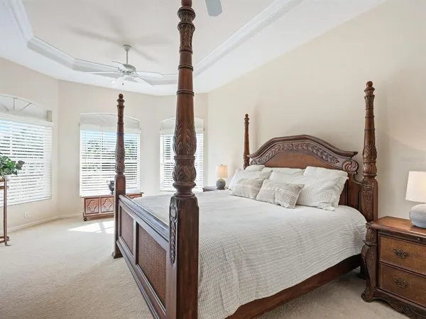 a view of a house with a big yard and palm trees