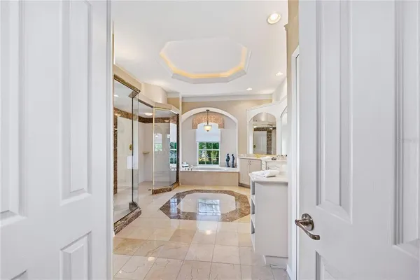 a front view of a house with a big yard and palm trees