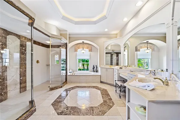 a bedroom with a bed and a dresser with mirror