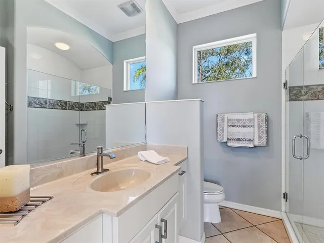 a kitchen with a sink a stove and chairs