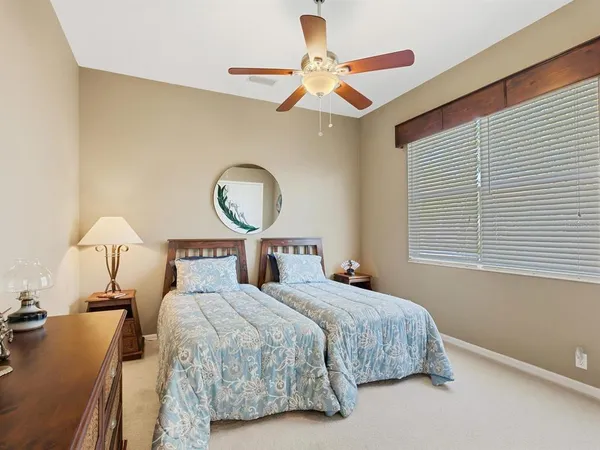 a living room with furniture kitchen view and a large window