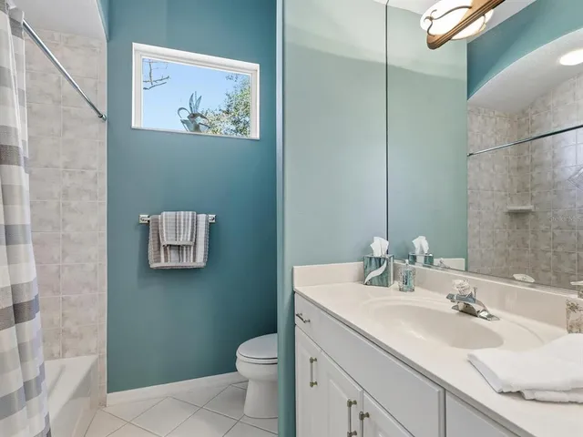 a living room with furniture a fireplace and a chandelier