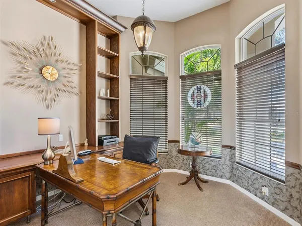 a view of a backyard with table and chairs potted plants