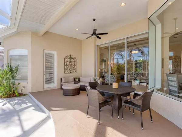 a view of a house with backyard and sitting area