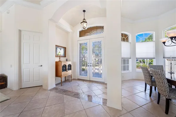 a living room with furniture a flat screen tv and a floor to ceiling window