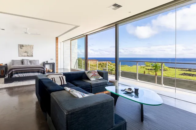 a living room with furniture and a floor to ceiling window