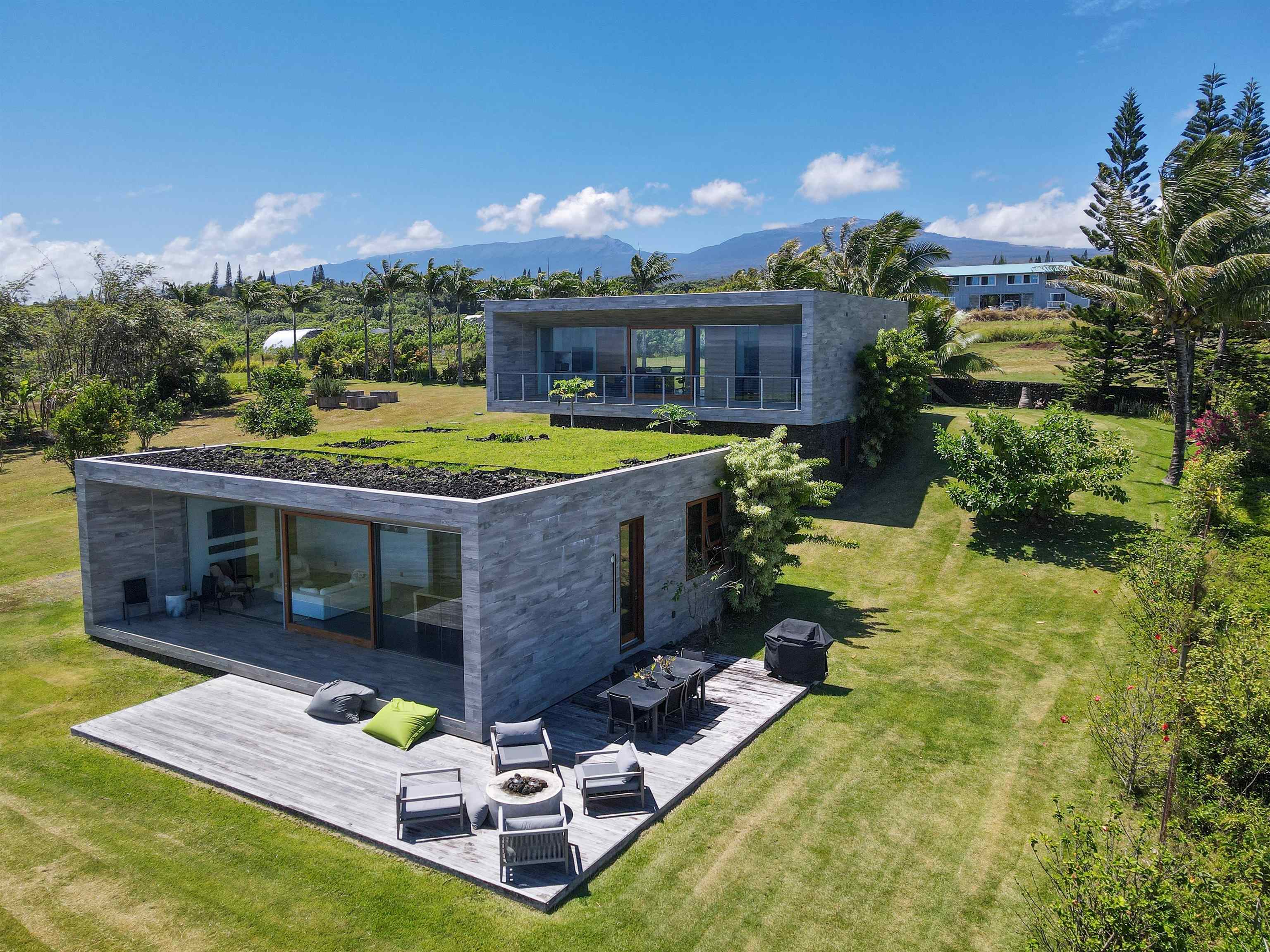 454 Hoolawa Road Haiku, HI 96708 - Photo 2 of 43 a view of a house with backyard outdoor seating area and furniture
