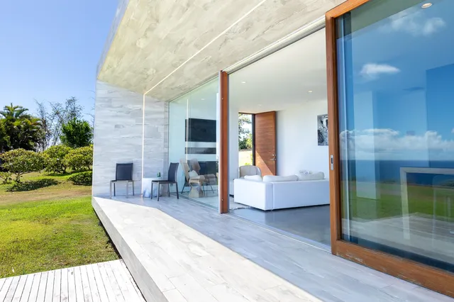 a view of a patio with couches table and chairs and potted plants